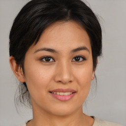 Joyful asian young-adult female with medium  brown hair and brown eyes