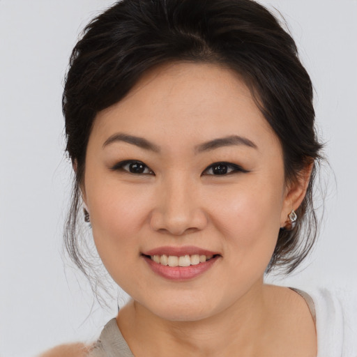 Joyful asian young-adult female with medium  brown hair and brown eyes