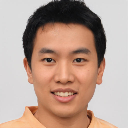 Joyful asian young-adult male with short  black hair and brown eyes