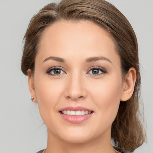 Joyful white young-adult female with medium  brown hair and brown eyes