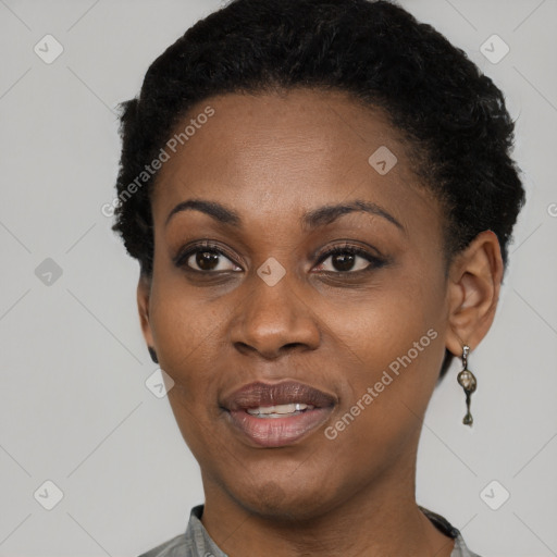 Joyful black young-adult female with short  black hair and brown eyes