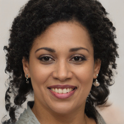 Joyful black young-adult female with medium  brown hair and brown eyes