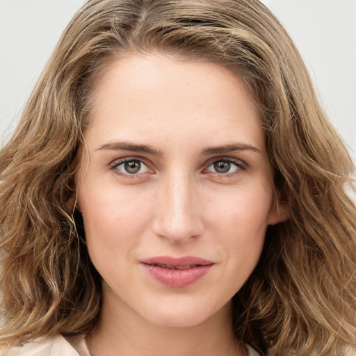 Joyful white young-adult female with long  brown hair and green eyes