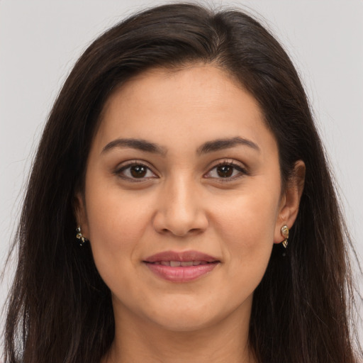Joyful latino young-adult female with long  brown hair and brown eyes