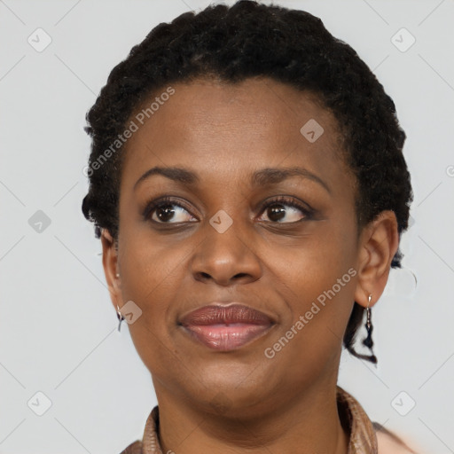 Joyful black adult female with short  brown hair and brown eyes