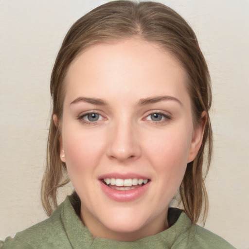 Joyful white young-adult female with medium  brown hair and grey eyes