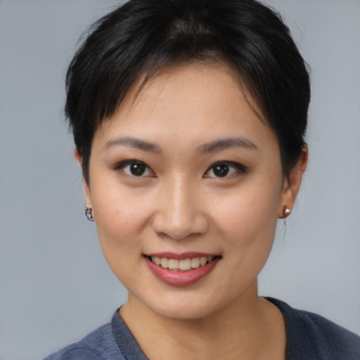 Joyful asian young-adult female with medium  brown hair and brown eyes