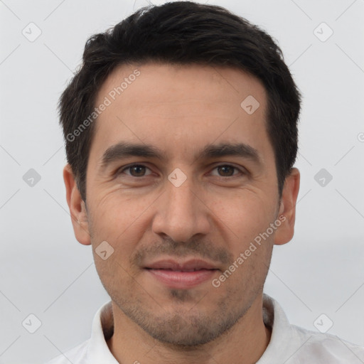 Joyful white young-adult male with short  black hair and brown eyes