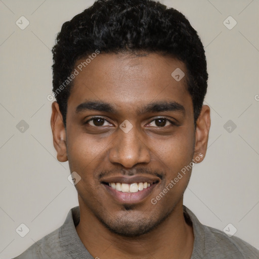 Joyful black young-adult male with short  black hair and brown eyes