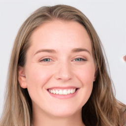 Joyful white young-adult female with long  brown hair and blue eyes