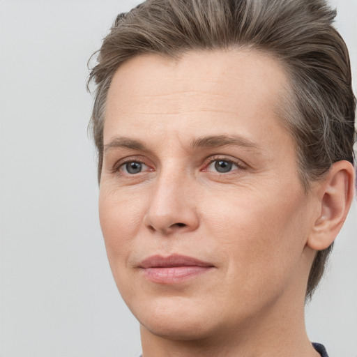 Joyful white adult female with short  brown hair and grey eyes