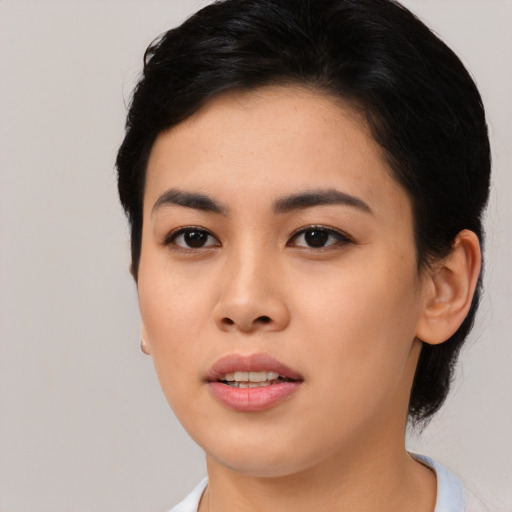 Joyful asian young-adult female with medium  black hair and brown eyes