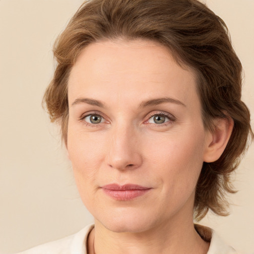 Joyful white young-adult female with medium  brown hair and green eyes