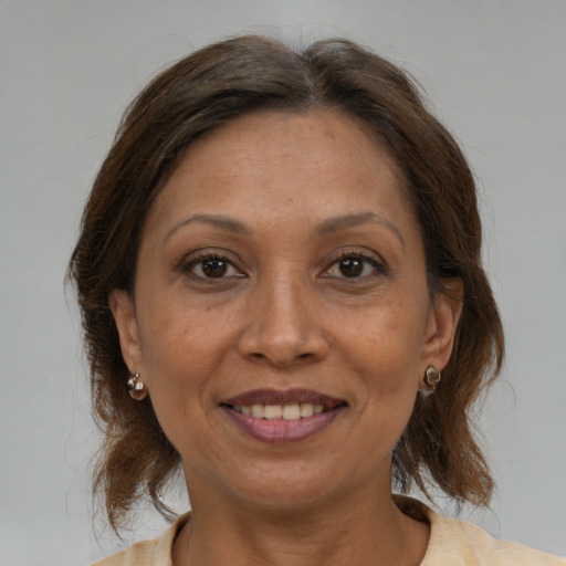 Joyful white adult female with medium  brown hair and brown eyes