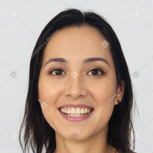 Joyful latino young-adult female with long  brown hair and brown eyes