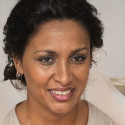 Joyful black adult female with medium  brown hair and brown eyes