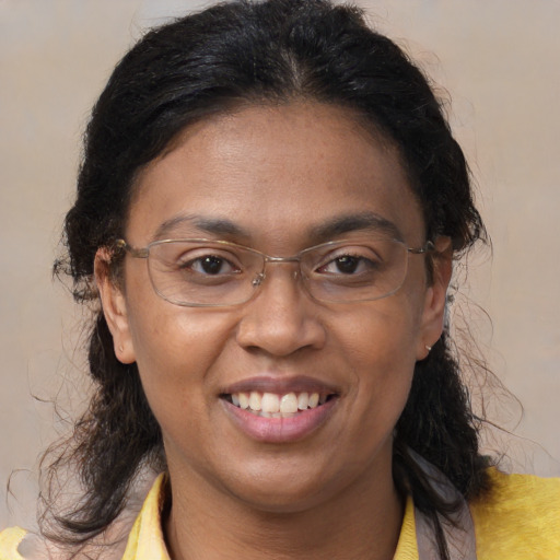 Joyful latino adult female with medium  brown hair and brown eyes