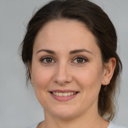 Joyful white adult female with medium  brown hair and brown eyes