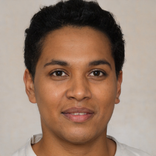 Joyful latino young-adult male with short  brown hair and brown eyes