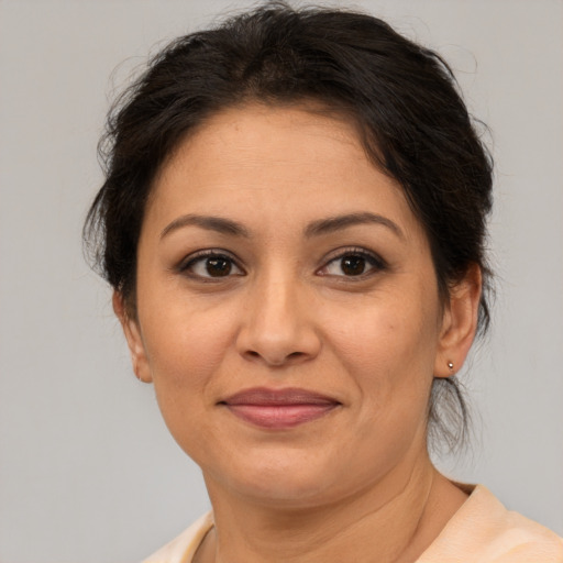 Joyful asian adult female with medium  brown hair and brown eyes