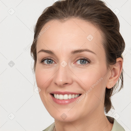 Joyful white young-adult female with medium  brown hair and grey eyes