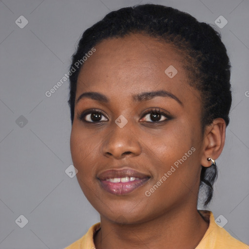 Joyful black young-adult female with short  black hair and brown eyes