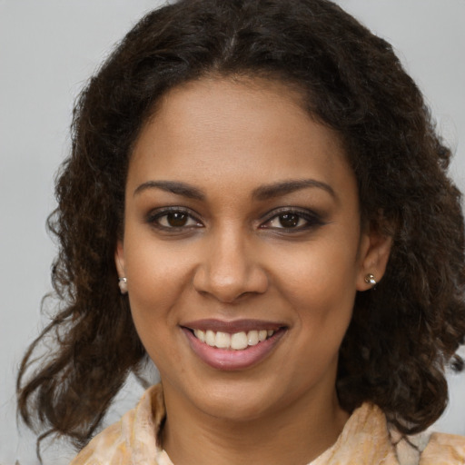 Joyful black young-adult female with medium  brown hair and brown eyes