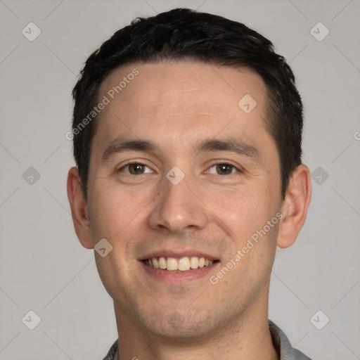 Joyful white young-adult male with short  black hair and brown eyes