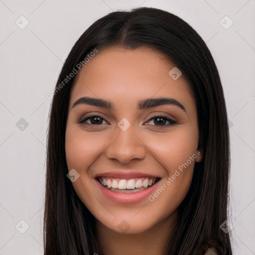 Joyful latino young-adult female with long  black hair and brown eyes