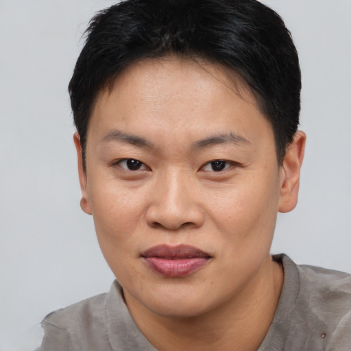 Joyful asian young-adult female with short  brown hair and brown eyes