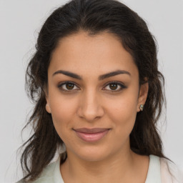 Joyful latino young-adult female with medium  brown hair and brown eyes