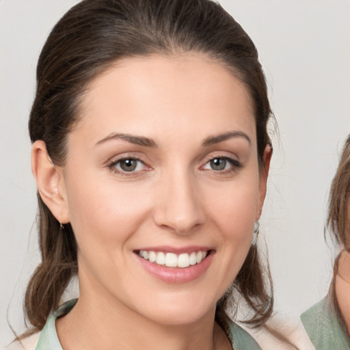 Joyful white young-adult female with medium  brown hair and brown eyes