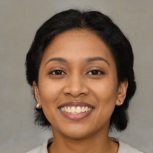 Joyful latino young-adult female with medium  black hair and brown eyes