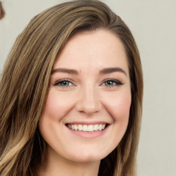 Joyful white young-adult female with long  brown hair and green eyes