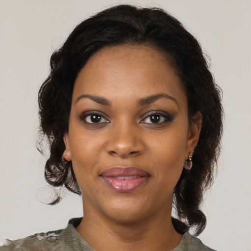 Joyful black young-adult female with medium  black hair and brown eyes