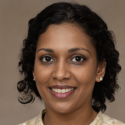 Joyful black young-adult female with medium  brown hair and brown eyes