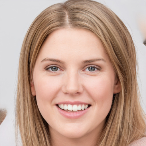 Joyful white young-adult female with long  brown hair and grey eyes