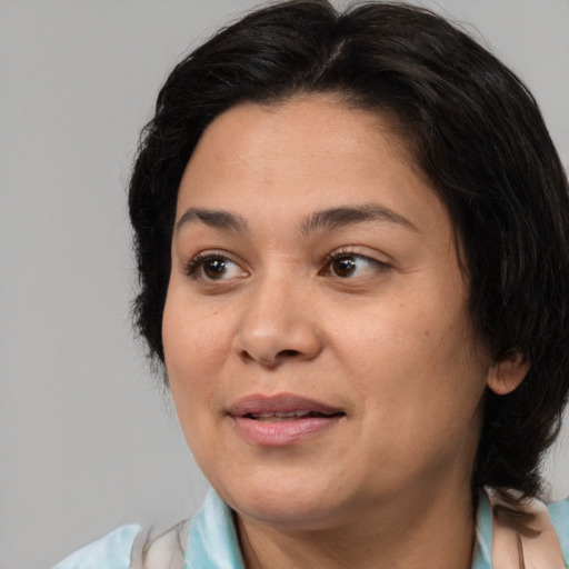 Joyful asian adult female with medium  brown hair and brown eyes