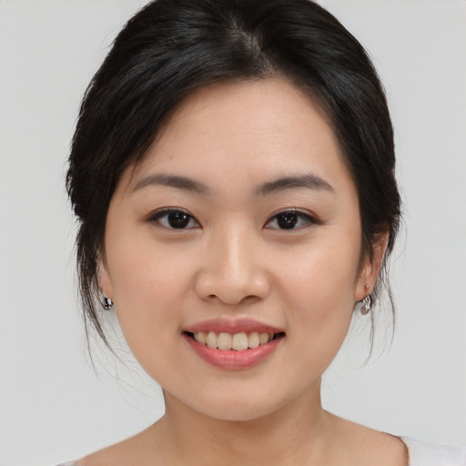 Joyful asian young-adult female with medium  brown hair and brown eyes