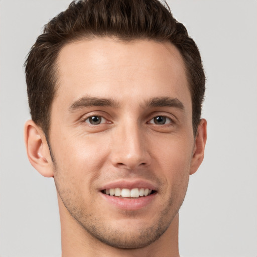 Joyful white young-adult male with short  brown hair and brown eyes