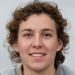 Joyful white young-adult female with medium  brown hair and blue eyes