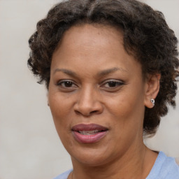 Joyful black adult female with short  brown hair and brown eyes