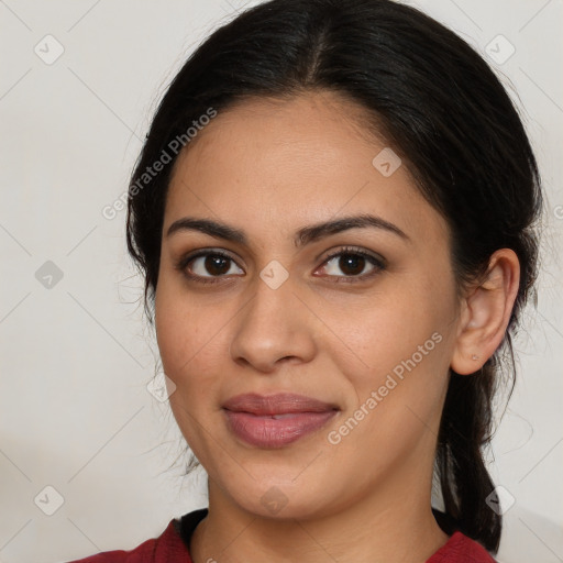 Joyful latino young-adult female with medium  brown hair and brown eyes