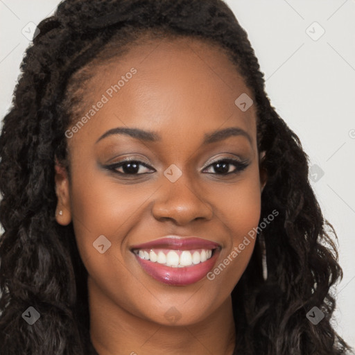 Joyful black young-adult female with long  brown hair and brown eyes