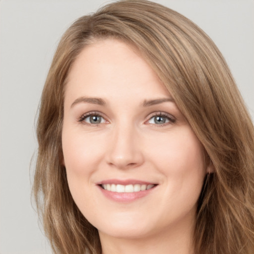 Joyful white young-adult female with long  brown hair and brown eyes