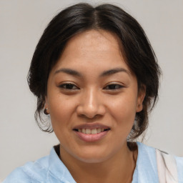 Joyful asian young-adult female with medium  brown hair and brown eyes