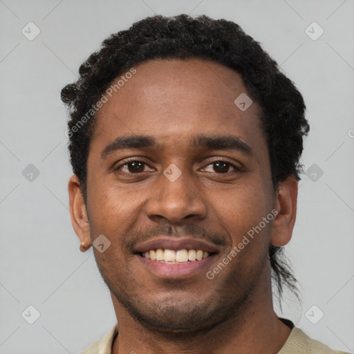 Joyful black young-adult male with short  black hair and brown eyes