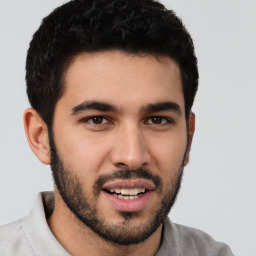 Joyful white young-adult male with short  black hair and brown eyes