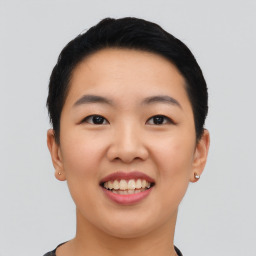 Joyful asian young-adult female with short  black hair and brown eyes