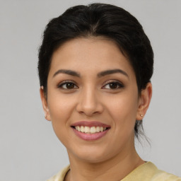 Joyful latino young-adult female with short  brown hair and brown eyes